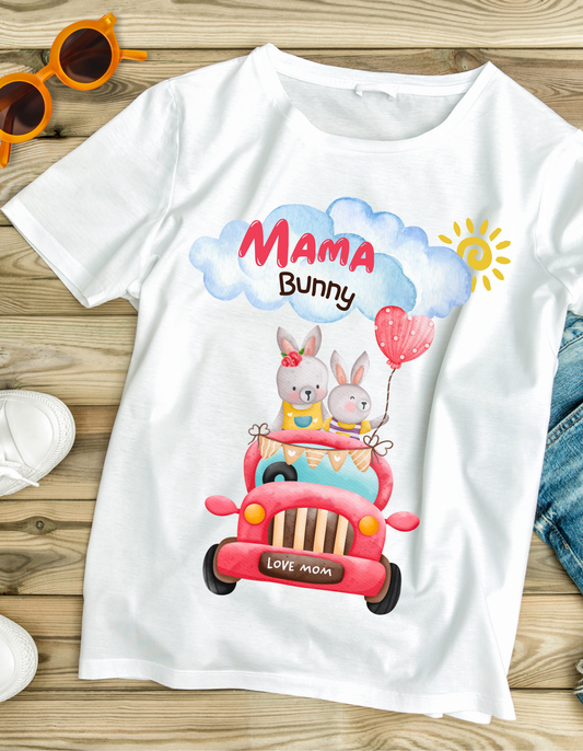 White organic cotton kids T-shirt from DoodleChic with Mama Bunny Love design showing bunnies in a red car under a sunny sky.