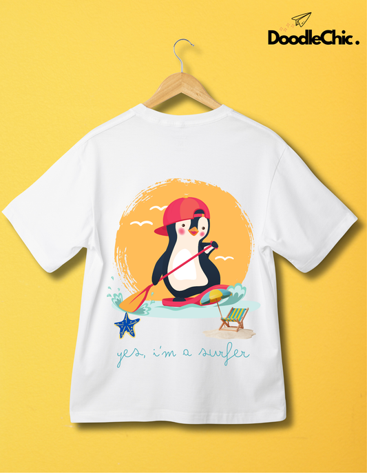 Back view of Penguin Surfer by DoodleChic - 100% Organic Cotton White Kids T-shirt with playful penguin surfing print, displayed on yellow wall.