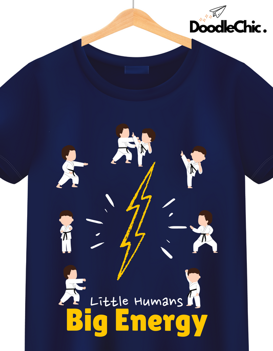 Close-up of Little Humans by DoodleChic navy blue kids T-shirt with bold 'Big Energy' text and martial arts-themed cartoon print.