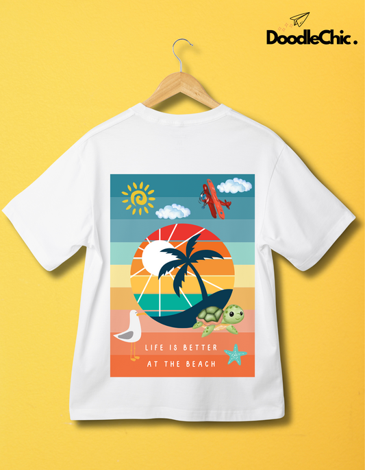 Beach by DoodleChic - 100% Organic Cotton White Printed Kids T-shirt hanging on yellow wall, featuring tropical beach print with palm tree and sun.