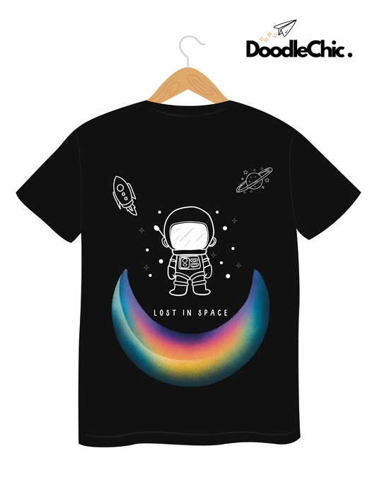 Space by DoodleChic - 100% Organic Cotton Black Printed Kids T-shirt on hanger, showing astronaut and space-themed rainbow graphic on the back.