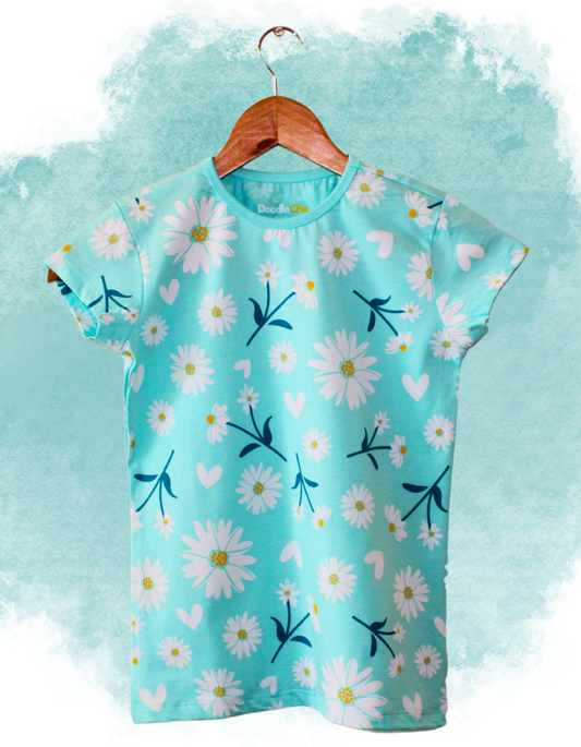 Eco-friendly Daisy Dream Delight girls' top by DoodleChic featuring all-over daisy print on soft organic cotton, styled on a watercolor background.
