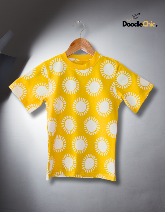 Morning Sunshine by DoodleChic - 100% Organic Cotton Kids T-shirt displayed under spotlight, showcasing vibrant yellow color and playful sun pattern.