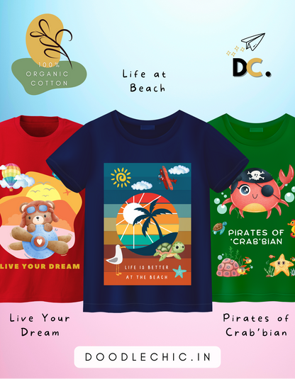 DoodleChic Pack of 3 Kids 100% Organic Cotton T-shirts featuring 'Pirates of Crab'bian', 'Live Your Dream', and 'Life at Beach'. Three children's t-shirts with colorful designs and text on a light blue background.