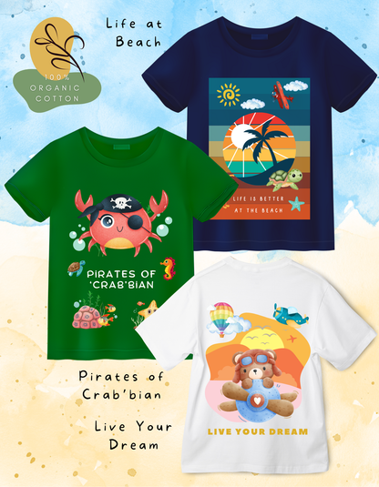 DoodleChic Pack of 3 Kids 100% Organic Cotton T-shirts featuring 'Pirates of Crab'bian', 'Live Your Dream', and 'Life at Beach'. Three children's t-shirts with colorful designs and text on a light blue background.